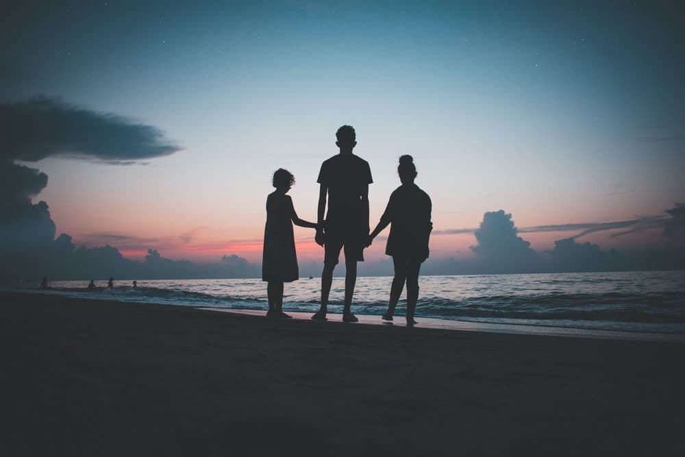 children_holding_hands_sunset